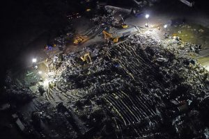 Biden proclaims an emergency as workers search storm debris